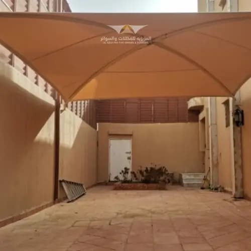 مظلات الشد الإنشائي بغشاء التيفلون (PTFE)
